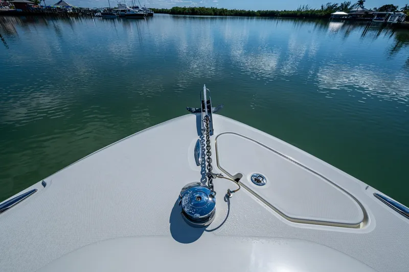 Slide: The Image of 2018 HCB 42 Siesta boat interior with open deck, clear sky, and waterfront view. - 40