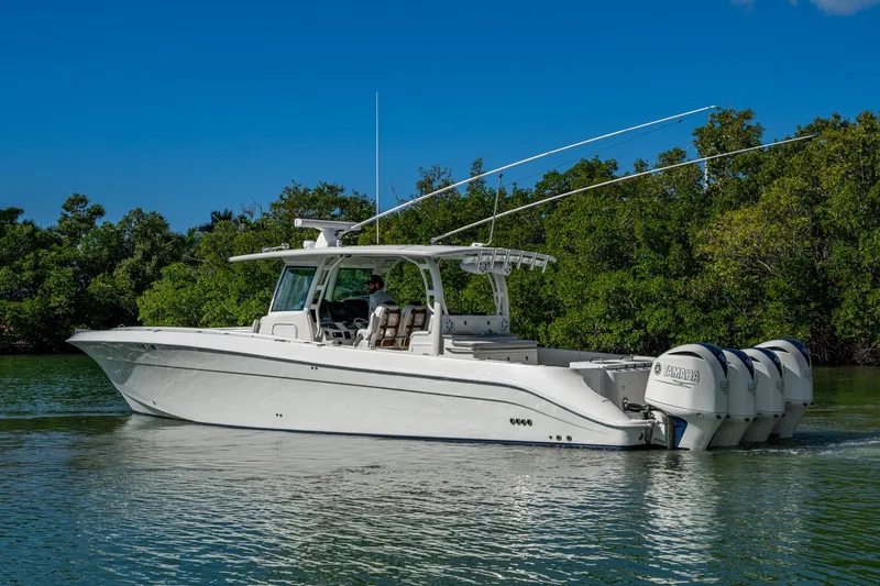 Slide: The Image of 2018 HCB 42 Siesta boat with Yamaha engines on a calm waterway. - 51