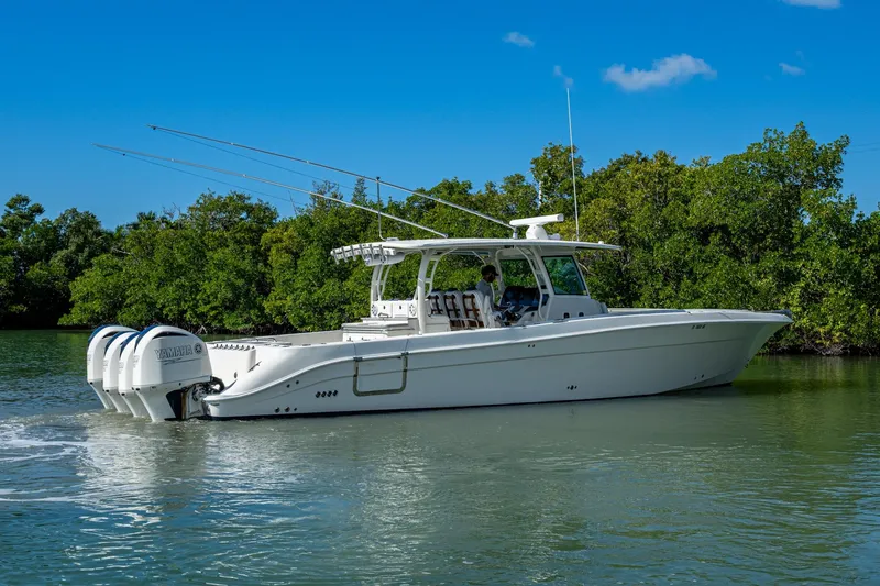 Slide: The Image of 2018 HCB 42 Siesta boat cruising on a calm waterway with lush greenery. - 55