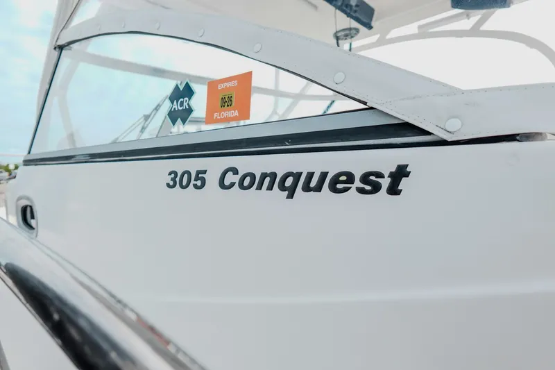 Slide: The Image of 2007 Boston Whaler 305 Conquest boat with Florida registration sticker. - 11