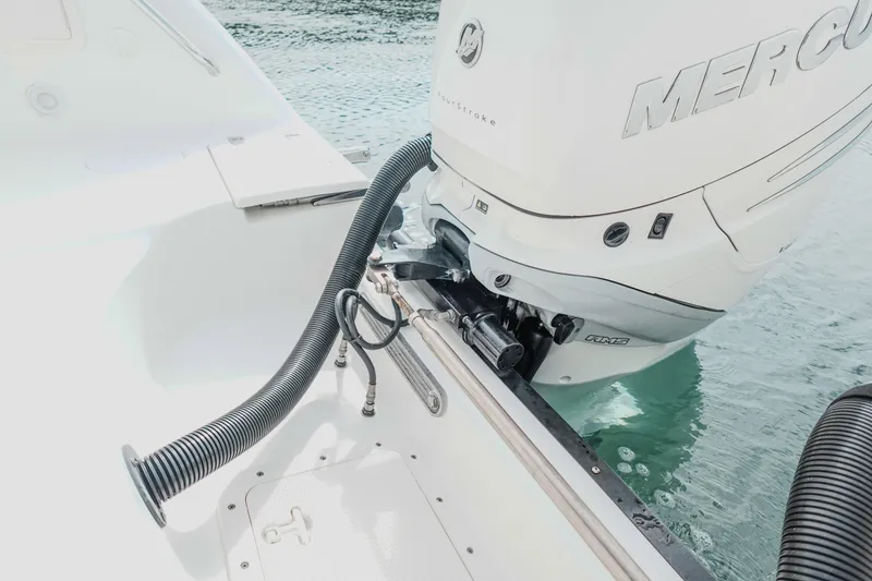 Slide: The Image of 2007 Boston Whaler 305 Conquest with Mercury outboard engine on water. - 19