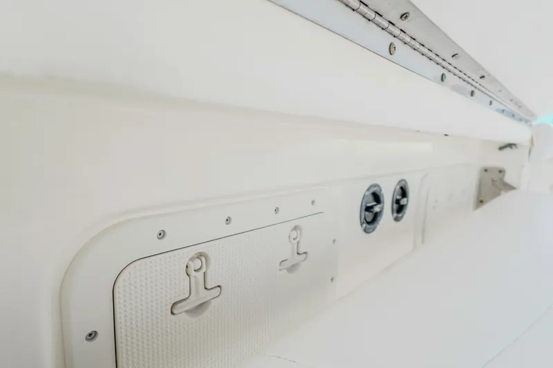Slide: The Image of 2007 Boston Whaler 305 Conquest interior detail, featuring storage compartments and fixtures. - 24