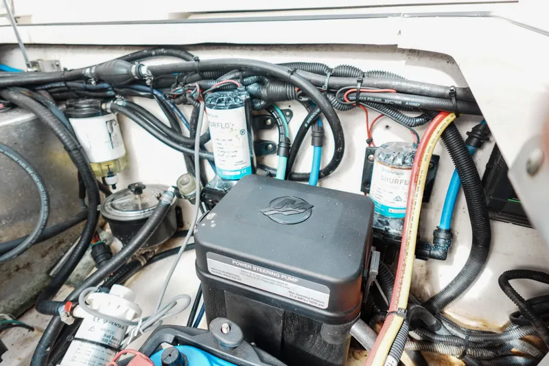 Slide: The Image of Engine compartment of a 2007 Boston Whaler 305 Conquest with visible wiring and components. - 25