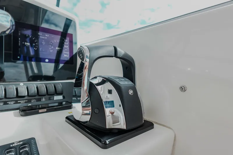 Slide: The Image of Control panel of 2007 Boston Whaler 305 Conquest boat, featuring modern throttle and display. - 30