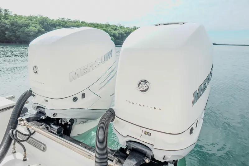 Slide: The Image of Twin Mercury outboard engines on a 2007 Boston Whaler 305 Conquest boat. - 34