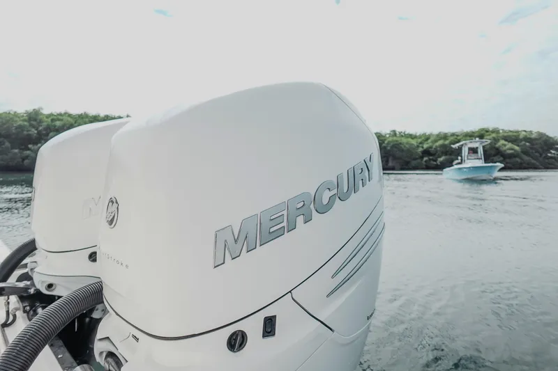 Slide: The Image of Twin Mercury outboard engines on a 2007 Boston Whaler 305 Conquest in scenic waters. - 35