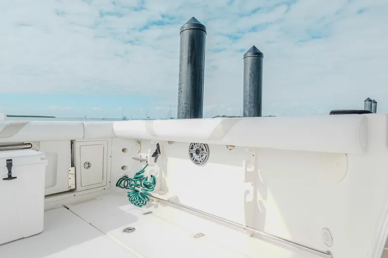 Slide: The Image of 2007 Boston Whaler 305 Conquest boat deck with storage and coiled hose. - 39