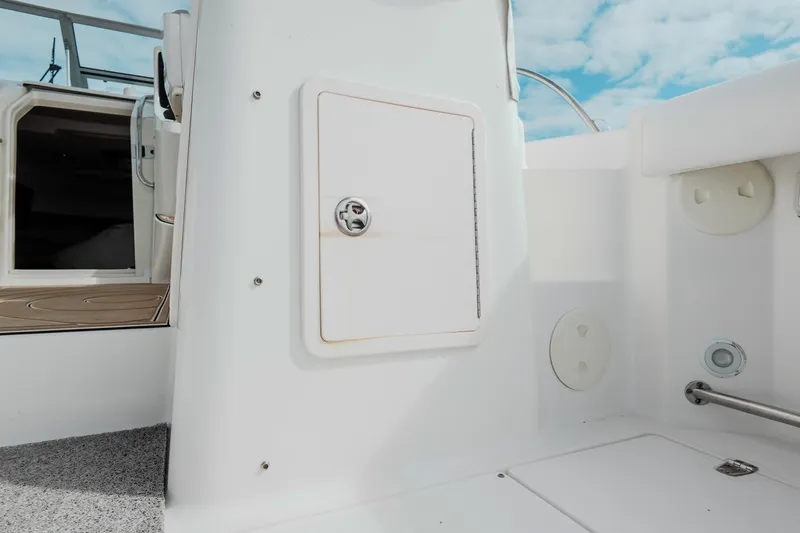 Slide: The Image of 2007 Boston Whaler 305 Conquest boat interior with storage compartment and deck view. - 42