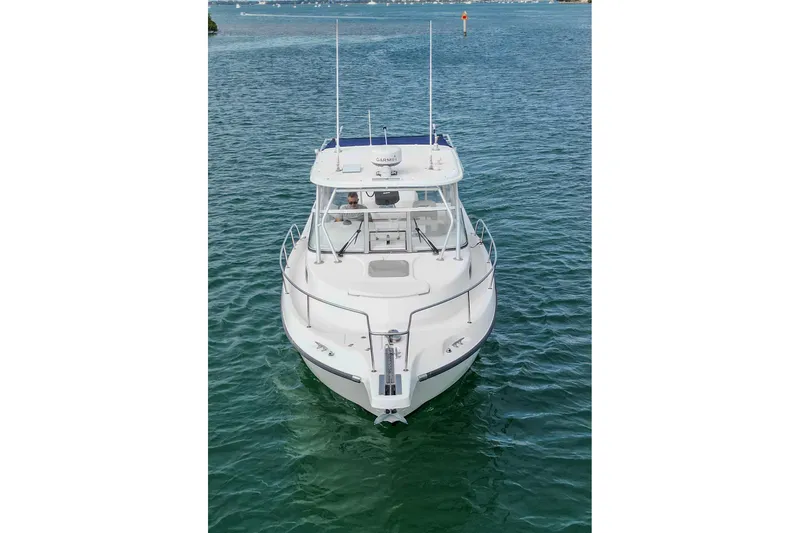 Slide: The Image of 2007 Boston Whaler 305 Conquest boat on calm water, front view. - 9