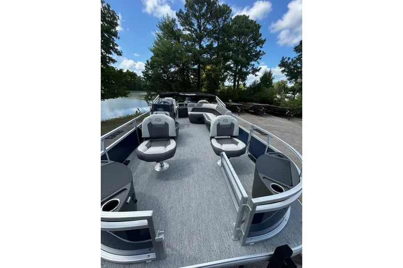 Slide: The Image of 2026 Sun Tracker Bass Buggy 18 DLX pontoon boat with spacious seating and scenic lake view. - 4