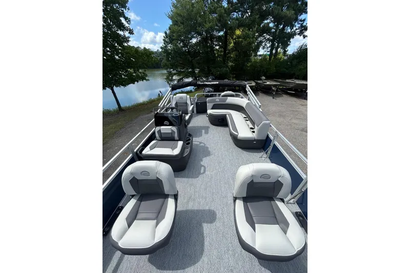 Slide: The Image of 2026 Sun Tracker Bass Buggy 18 DLX pontoon boat with spacious seating and scenic lake view. - 6