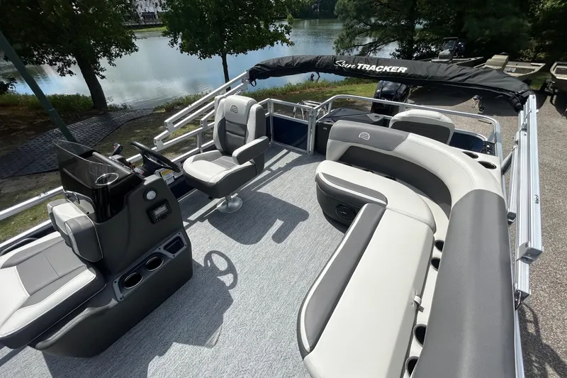 Slide: The Image of 2026 Sun Tracker Bass Buggy 18 DLX pontoon boat interior with seating and steering console. - 7