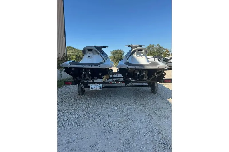 Slide: The Image of Two 2012 Yamaha WaveRunner VX Cruisers on a trailer, parked on gravel. - 4
