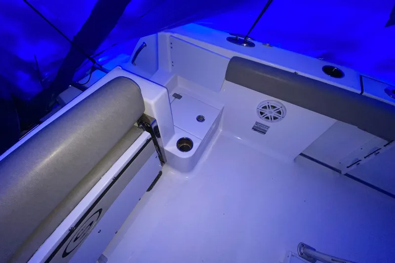 Slide: The Image of 2021 Sportsman Open 242 Center Console boat interior with blue lighting. - 21