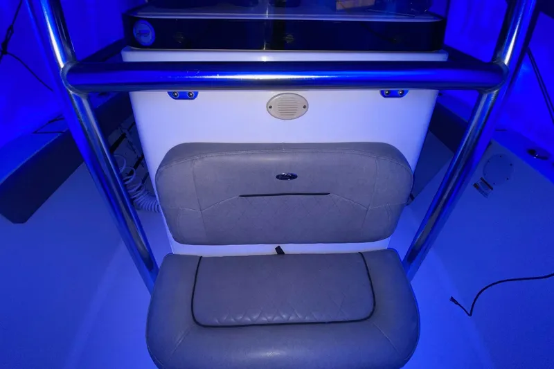 Slide: The Image of 2021 Sportsman Open 242 Center Console interior with blue lighting and cushioned seating. - 23