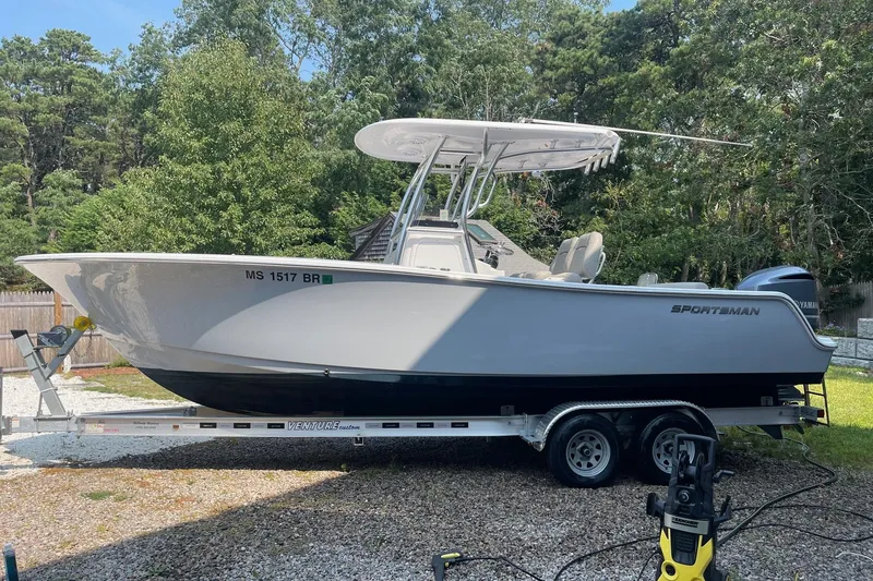 Slide: The Image of 2021 Sportsman Open 242 Center Console boat on trailer, parked outdoors. - 27