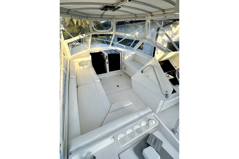 Slide: The Image of 2006 Contender 35 Express Side Console boat interior with white seating and helm. - 12