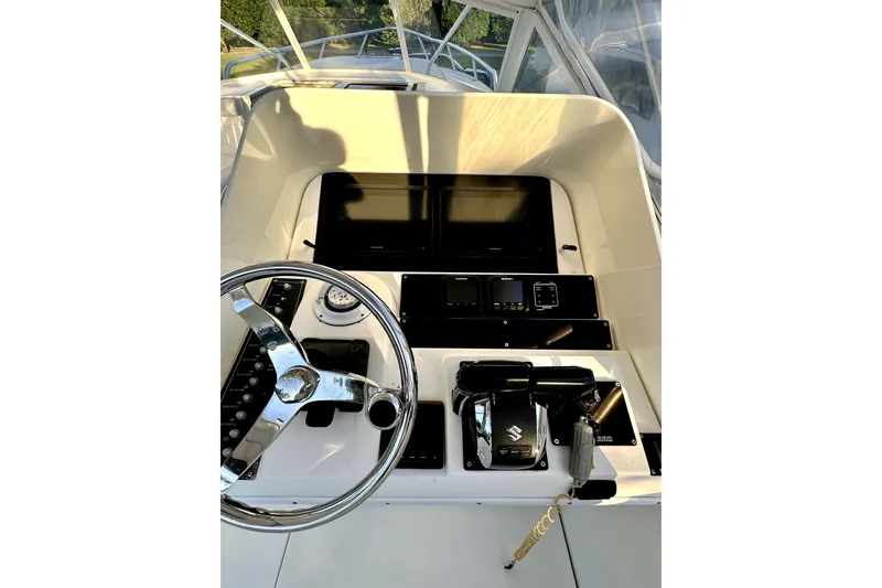 Slide: The Image of 2006 Contender 35 Express Side Console helm with steering wheel and control panel. - 14