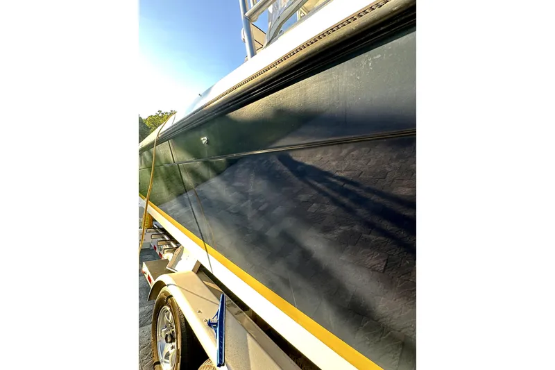 Slide: The Image of 2006 Contender 35 Express Side Console boat on trailer, close-up view. - 16