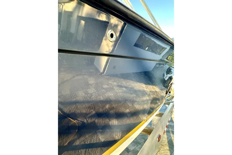 Slide: The Image of 2006 Contender 35 Express Side Console boat hull, reflecting surroundings. - 17