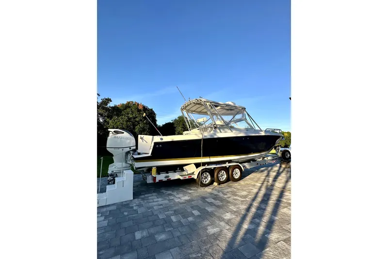 Slide: The Image of 2006 Contender 35 Express Side Console boat on trailer, parked outdoors. - 18