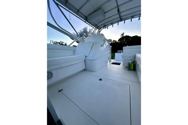 Slide: The Image of 2006 Contender 35 Express Side Console boat interior with seating and canopy. - 2