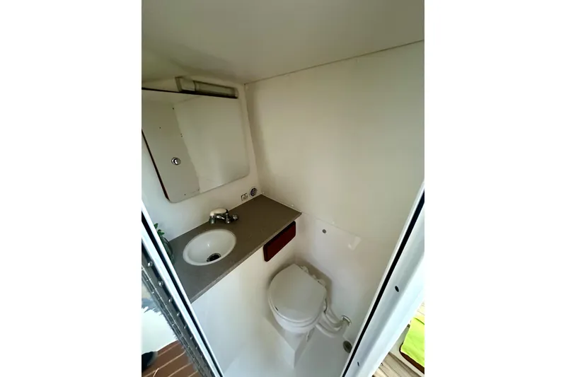 Slide: The Image of 2006 Contender 35 Express Side Console bathroom with sink and toilet. - 3