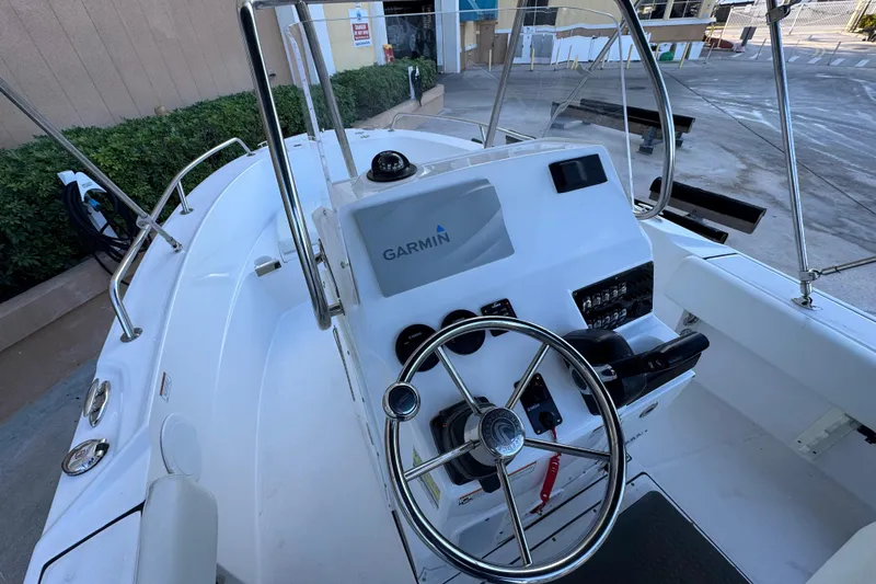 Slide: The Image of 2023 Edgewater 188CC boat cockpit with Garmin navigation system and steering wheel. - 10