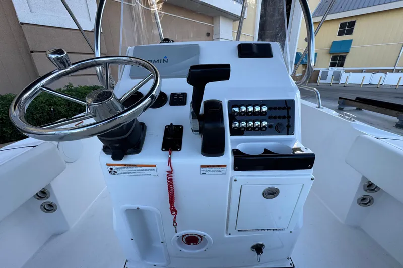 Slide: The Image of 2023 Edgewater 188CC boat console with steering wheel and control panel. - 12