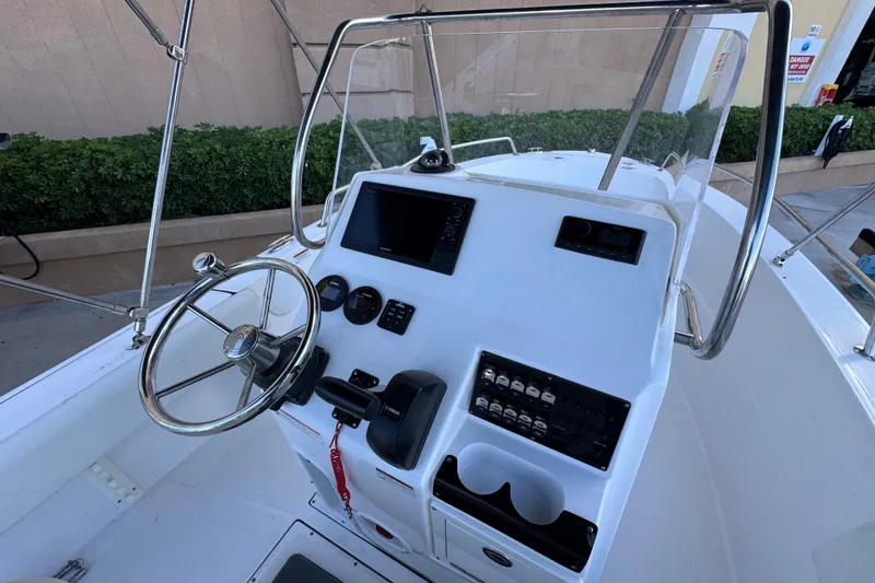 Slide: The Image of 2023 Edgewater 188CC boat console with steering wheel and control panel. - 13