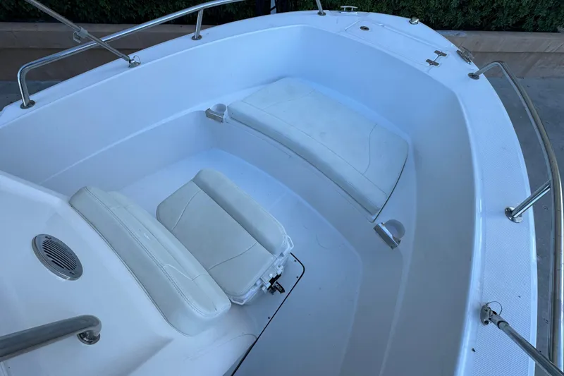 Slide: The Image of 2023 Edgewater 188CC boat interior with white cushioned seating and stainless steel railings. - 15