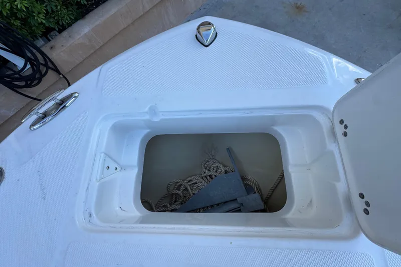 Slide: The Image of Open anchor storage on 2023 Edgewater 188CC boat, featuring ropes and anchor. - 16