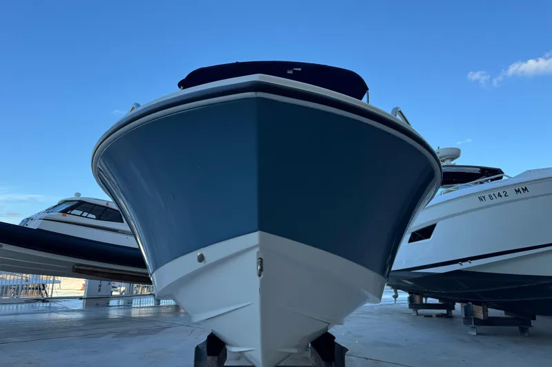 Slide: The Image of 2023 Edgewater 188CC boat displayed in a marina, surrounded by other vessels. - 2