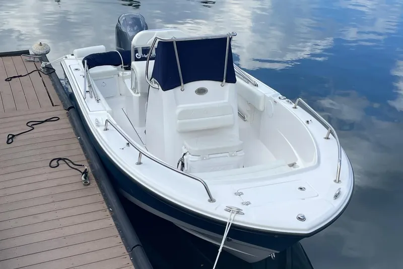 Slide: The Image of 2023 Edgewater 188CC boat docked on calm water, showcasing sleek design and modern features. - 7