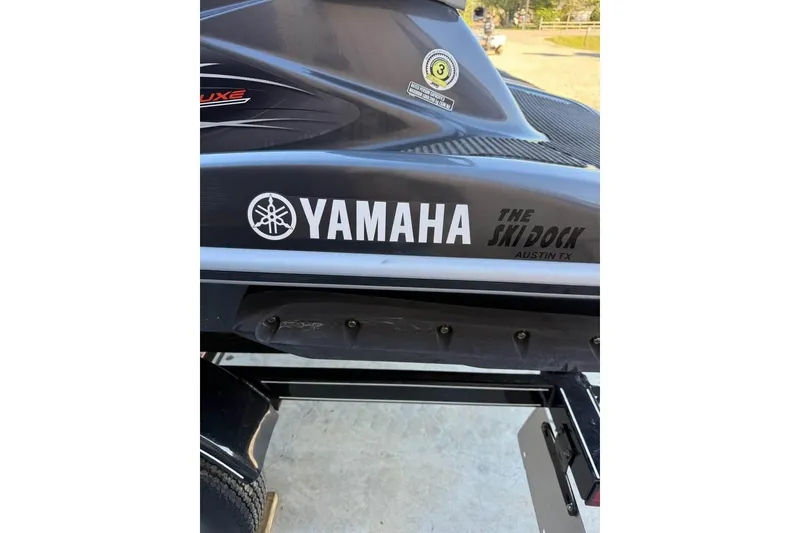 Slide: The Image of 2013 Yamaha WaveRunner VXR jet ski with branding, parked on a trailer. - 7