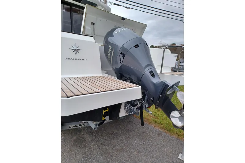Slide: The Image of 2022 Jeanneau NC 695 Sport Serie 2 with Yamaha outboard motor, rear view. - 10