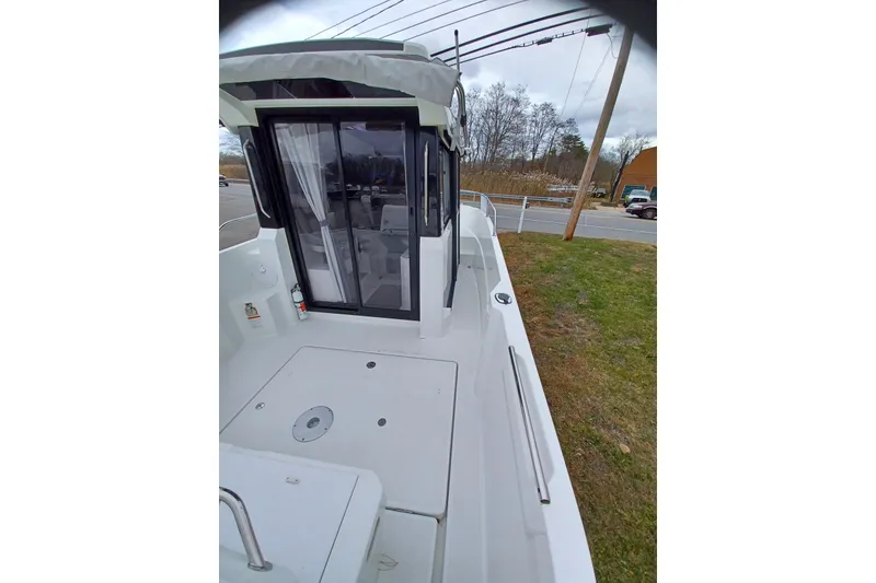 Slide: The Image of 2022 Jeanneau NC 695 Sport Serie 2 boat, exterior view with sliding glass door. - 11