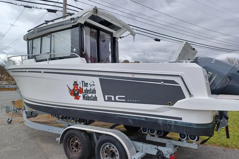 Slide: The Image of 2022 Jeanneau NC 695 Sport Serie 2 boat on trailer, featuring "The Lobstah Mobstah" graphic. - 3