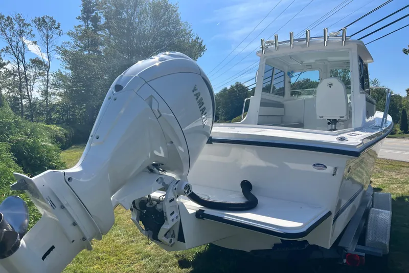 Slide: The Image of 2026 Steiger Craft 23 DV Miami boat with Yamaha outboard motor, parked on grass. - 11