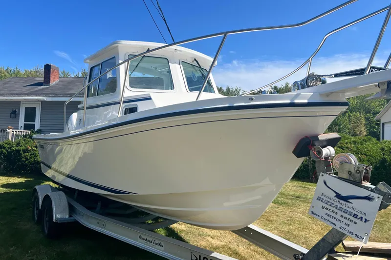 The Image of 2026 Steiger Craft 23 DV Miami boat on trailer, parked in a residential yard. - 2
