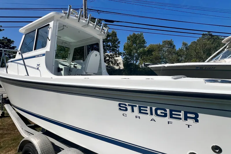 Slide: The Image of 2026 Steiger Craft 23 DV Miami boat on trailer, side view, clear sky background. - 4