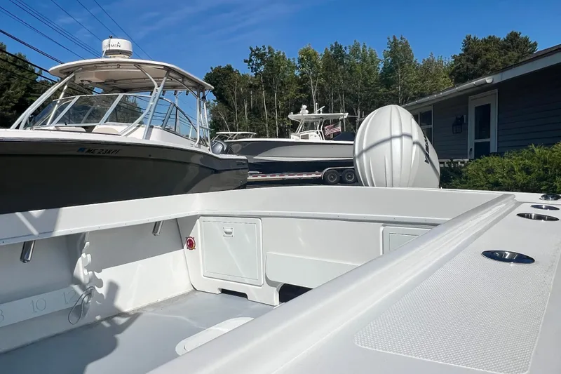 Slide: The Image of 2026 Steiger Craft 23 DV Miami boat docked, surrounded by trees and a house. - 9