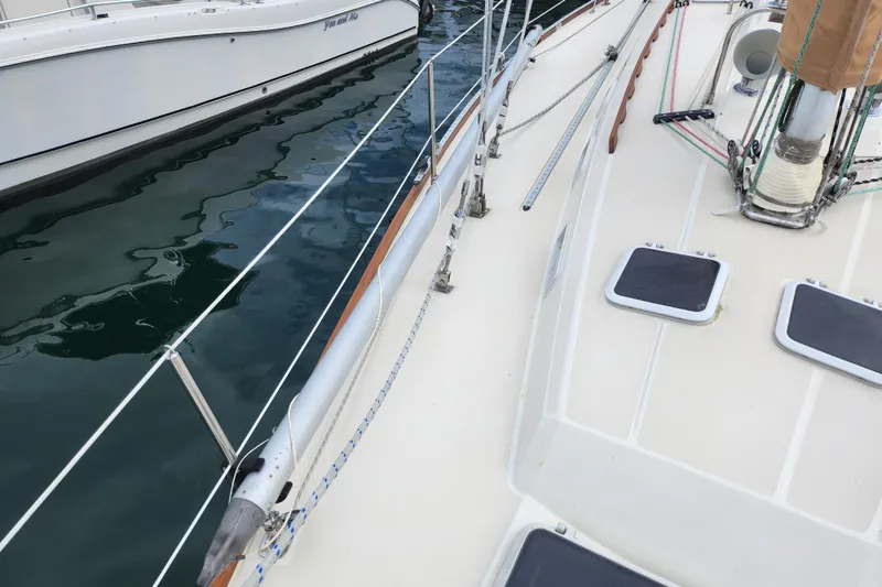 Slide: The Image of 1988 Sabre 42 sailboat deck with rigging and water reflection. - 10