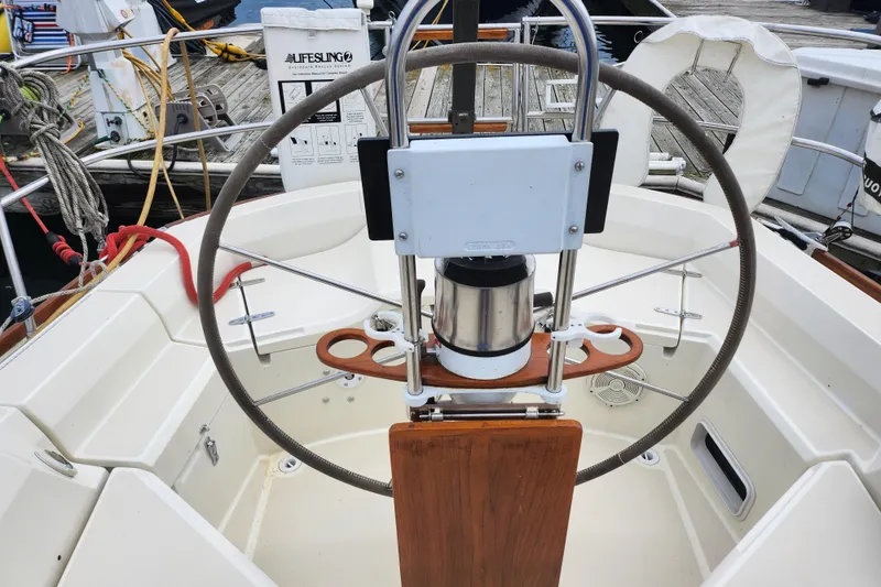 Slide: The Image of Cockpit of a 1988 Sabre 42 sailboat with steering wheel and navigation equipment. - 12