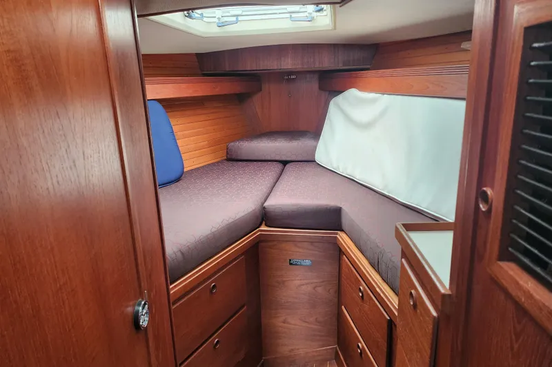 Slide: The Image of 1988 Sabre 42 yacht cabin with wooden interior and cozy V-berth. - 19