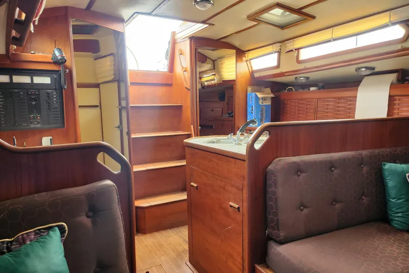 Slide: The Image of Interior of a 1988 Sabre 42 sailboat with wooden cabinetry and cozy seating. - 25