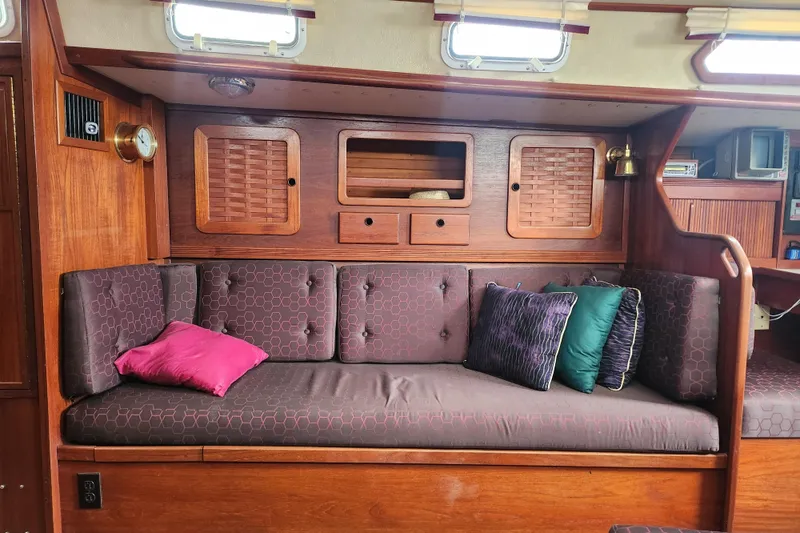 Slide: The Image of Interior of 1988 Sabre 42 sailboat with cushioned seating and wooden cabinetry. - 27