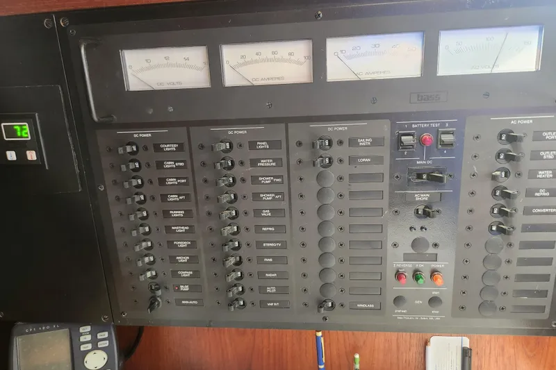 Slide: The Image of Electrical control panel on a 1988 Sabre 42 boat, featuring various switches and gauges. - 28