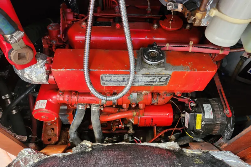 Slide: The Image of Engine compartment of a 1988 Sabre 42 sailboat featuring a red Westerbeke engine. - 31