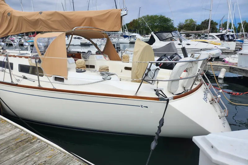 Slide: The Image of 1988 Sabre 42 sailboat docked in marina, featuring tan covers and sleek design. - 4